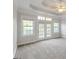 The main bedroom has neutral carpet, many windows for natural light and access to the backyard at 161 Pleasant Grove Rd, Mcdonough, GA 30252