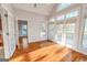 Sunroom bathed in natural light, featuring hardwood floors and multiple windows at 161 Pleasant Grove Rd, Mcdonough, GA 30252
