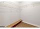 Spacious walk-in closet with custom shelving and a built-in bench for added convenience at 161 Pleasant Grove Rd, Mcdonough, GA 30252