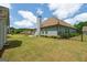 Well-maintained backyard with lush lawn, flower beds, and a charming exterior view of the home's architecture at 207 Brookstone Dr, Carrollton, GA 30116