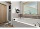 Bathroom highlighting soaking tub, tiled backsplash, shower, and window with view of the backyard at 207 Brookstone Dr, Carrollton, GA 30116