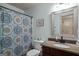 Bathroom featuring vanity, toilet, mirror and colorful patterned shower curtain at 207 Brookstone Dr, Carrollton, GA 30116
