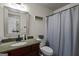 Bathroom featuring granite countertop vanity, framed mirror and shower with white patterned curtain at 207 Brookstone Dr, Carrollton, GA 30116
