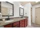 Bathroom boasts double vanity, granite countertops, framed mirrors, and plenty of cabinets at 207 Brookstone Dr, Carrollton, GA 30116