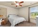 Bedroom with carpet, ceiling fan, bed, rocking chair, and large window with view of the pond at 207 Brookstone Dr, Carrollton, GA 30116