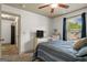 Bedroom with carpet, ceiling fan, bed with striped bedding, and window with view of greenery at 207 Brookstone Dr, Carrollton, GA 30116