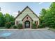Community clubhouse entrance with stone accents, landscaping, and ample parking, perfect for community gatherings at 207 Brookstone Dr, Carrollton, GA 30116