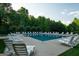 Sparkling community pool surrounded by lounge chairs, offering a relaxing and enjoyable experience at 207 Brookstone Dr, Carrollton, GA 30116
