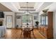 Charming dining room with a tray ceiling, hardwood floors, and an elegant light fixture at 207 Brookstone Dr, Carrollton, GA 30116