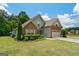 Lovely home showcasing stone and blue siding, complemented by a lush green lawn and an attached two-car garage at 207 Brookstone Dr, Carrollton, GA 30116