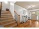 Elegant foyer showcasing hardwood floors, staircase with iron spindles, and a console table with decor at 207 Brookstone Dr, Carrollton, GA 30116