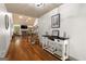 Inviting foyer with hardwood floors, white console table, and staircase leading to the upper level at 207 Brookstone Dr, Carrollton, GA 30116