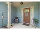 Cozy front porch with rocking chair, 'Home Sweet Home' door decor, and 'Welcome' doormat at 207 Brookstone Dr, Carrollton, GA 30116