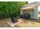 Outdoor grill area with a canopy, fire pit, and well-kept lawn, perfect for backyard entertaining and cooking at 207 Brookstone Dr, Carrollton, GA 30116