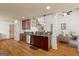 Open-concept kitchen featuring stainless steel appliances, granite countertops, and hardwood floors at 207 Brookstone Dr, Carrollton, GA 30116