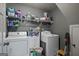 Functional laundry room with modern appliances and storage shelves at 207 Brookstone Dr, Carrollton, GA 30116