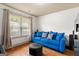 Bright living room with hardwood floors, blue sofa, and window at 207 Brookstone Dr, Carrollton, GA 30116