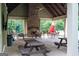 Covered pavilion with stone fireplace, ceiling fan, and picnic tables by the community pool at 207 Brookstone Dr, Carrollton, GA 30116