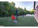 Community playground area with swings and artificial turf, providing a safe space for children to play at 207 Brookstone Dr, Carrollton, GA 30116