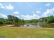 Scenic view of a tranquil pond surrounded by lush trees, creating a peaceful and serene atmosphere at 207 Brookstone Dr, Carrollton, GA 30116