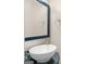 Elegant powder room featuring a vessel sink, designer mirror, and stylish fixtures at 30 Stonewall Dr, Covington, GA 30016