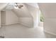 Bright carpeted bedroom featuring a window and sloped ceilings at 30 Stonewall Dr, Covington, GA 30016