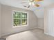 Bright bedroom with carpet flooring and a large window with treed view at 30 Stonewall Dr, Covington, GA 30016