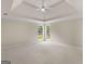 Spacious bedroom with tray ceiling, plush carpet, and natural light streaming through the windows at 30 Stonewall Dr, Covington, GA 30016
