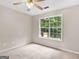 Bedroom featuring carpet flooring, a ceiling fan and a large window at 30 Stonewall Dr, Covington, GA 30016