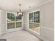 A dining area with two large windows and new pendant lighting at 30 Stonewall Dr, Covington, GA 30016