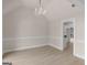 Dining room features a vaulted ceiling, chandelier, and opens to the adjacent kitchen area at 30 Stonewall Dr, Covington, GA 30016