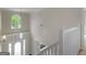 Bright entryway featuring a pendant light and staircase with white railing at 30 Stonewall Dr, Covington, GA 30016