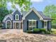 Beautiful home featuring a modern design, well-manicured lawn, and charming architectural details at 30 Stonewall Dr, Covington, GA 30016