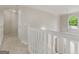 Hallway with carpet flooring featuring the white railing to the entryway at 30 Stonewall Dr, Covington, GA 30016