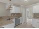 Kitchen featuring granite counters, stainless steel appliances and white cabinets at 30 Stonewall Dr, Covington, GA 30016