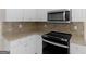 A kitchen featuring stainless steel appliances, granite countertops and white cabinets at 30 Stonewall Dr, Covington, GA 30016