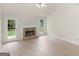 Bright living room with stone fireplace and door with backyard access at 30 Stonewall Dr, Covington, GA 30016