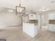 Open-concept room with kitchen island and a large, open living area at 30 Stonewall Dr, Covington, GA 30016