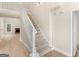 View of the home's staircase with white railings, carpeted steps, and an inviting entrance area at 30 Stonewall Dr, Covington, GA 30016
