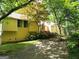 Charming yellow home with wood accents and mature trees in a tranquil setting at 363 Weatherstone Ln, Marietta, GA 30068