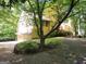 Yellow home with a two-car garage, mature trees, and inviting curb appeal at 363 Weatherstone Ln, Marietta, GA 30068