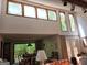 Sunlit living room with high ceilings, large windows, and a view of the deck and backyard at 363 Weatherstone Ln, Marietta, GA 30068