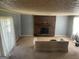 Cozy living room with a brick fireplace, carpeted floor, and lots of natural light at 1028 Dixie Dr, Jonesboro, GA 30236