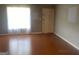 Bright living room featuring wood floors, a window with sheer curtains, and a neutral wall color at 1028 Dixie Dr, Jonesboro, GA 30236