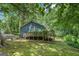 View of house exterior showing a deck surrounded by green trees at 357 Oak Hill Rd, Covington, GA 30016