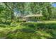 Beautiful backyard showcasing lush greenery and a creek, creating a serene and private setting at 357 Oak Hill Rd, Covington, GA 30016