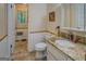 Bathroom features a toilet and vanity with granite countertops and white paneling at 357 Oak Hill Rd, Covington, GA 30016