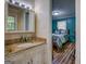 Bathroom with a vanity and granite countertops, and a view into the bedroom at 357 Oak Hill Rd, Covington, GA 30016