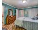 Cozy bedroom features a comfortable bed and classic wooden dresser with a decorative mirror at 357 Oak Hill Rd, Covington, GA 30016