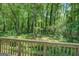 Beautiful backyard view from the wooden deck, showcasing mature trees and lush greenery at 357 Oak Hill Rd, Covington, GA 30016